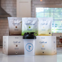 Thrive Protocol OptiFuel and OptiCharge product packets, boxes, and shaker cup.